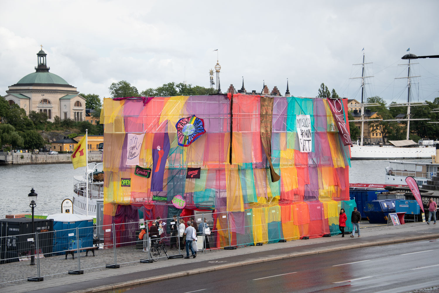 View of the water in the center of Stockhlm, with a colourful artwork placed just by the water.