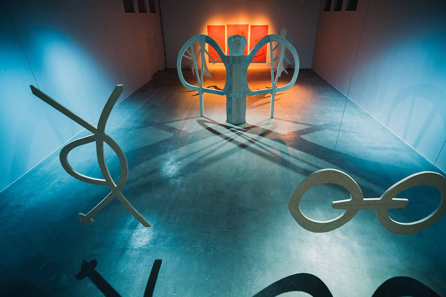 A room with wooden shapes hanging from the ceiling.