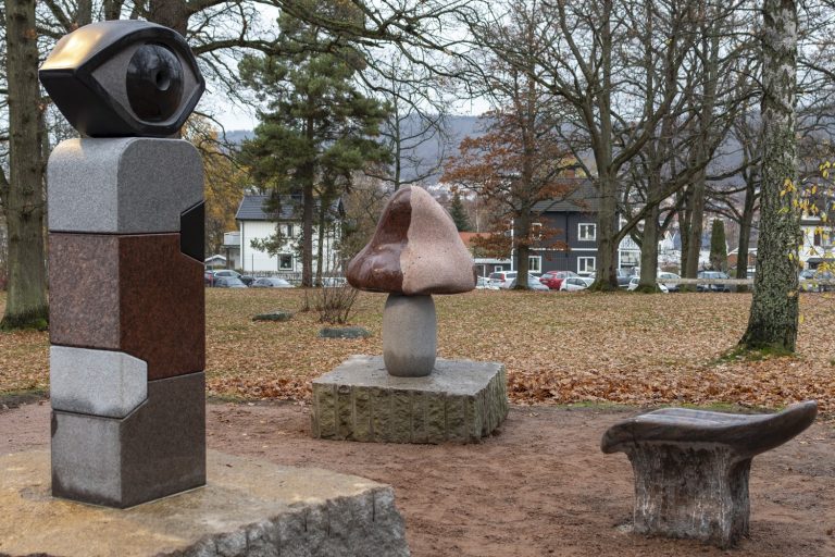 Image of three parts of the art work Let's face it. An eye, a nose and a tongue made of stone.
